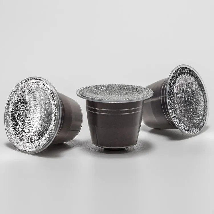 Coffee capsules sealed with embossed aluminium lids