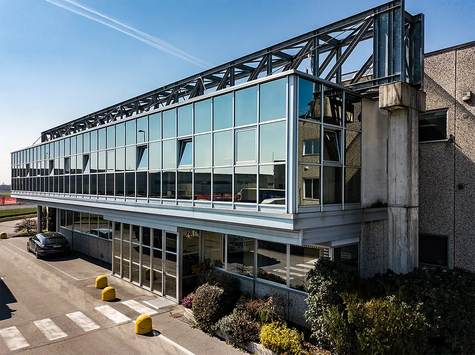 The Aluberg building in Bagnatica, glass and steel under a clear sky